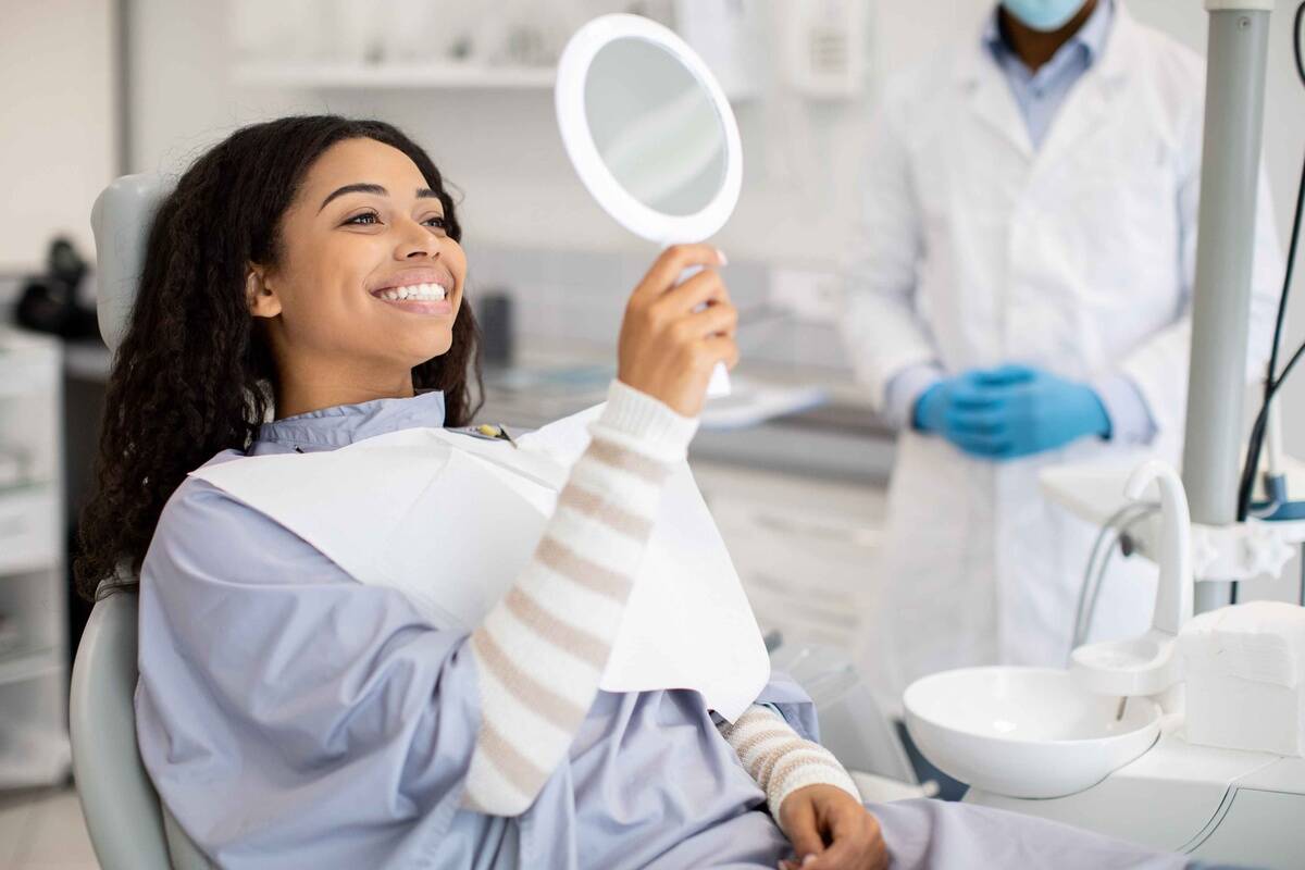 Patient smiling after discussing natural smile improvements with a cosmetic dentist