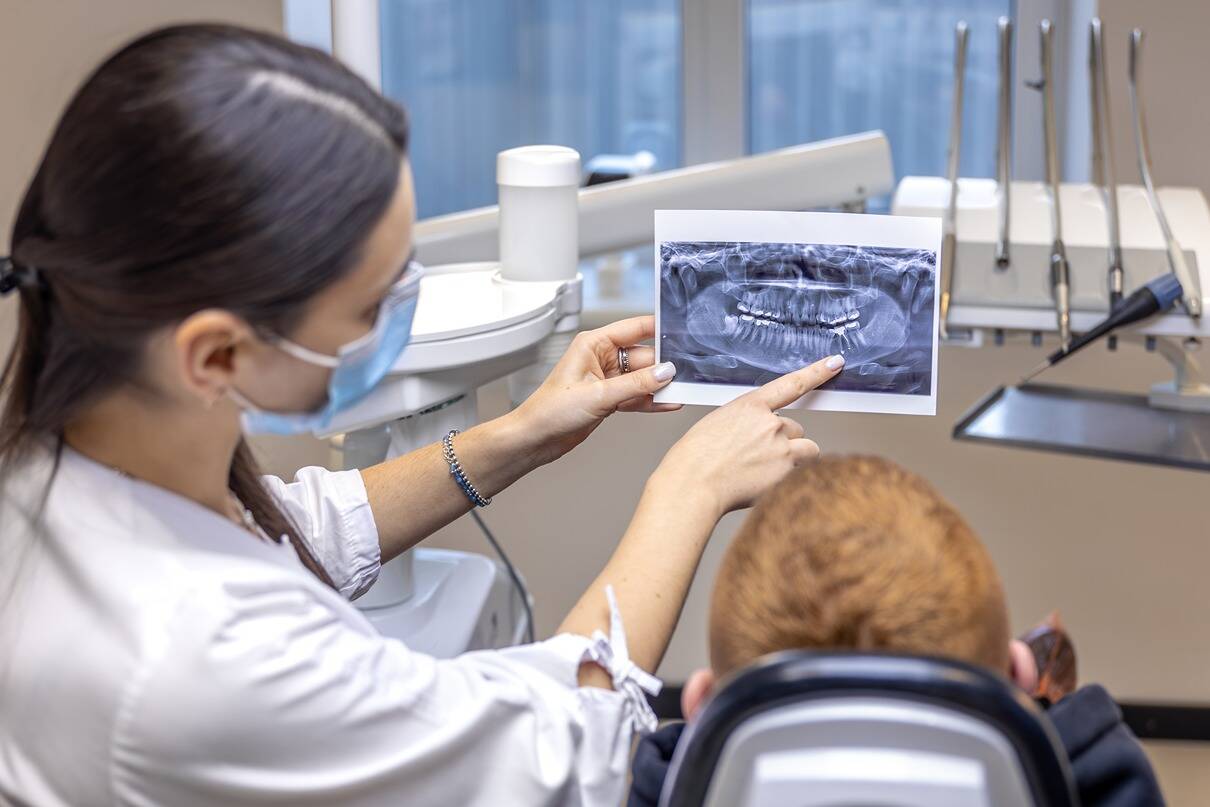 young-female-dentist-showing-patient-dental-xray-dentistry-concept